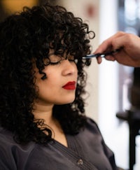 a woman getting her hair done in a salon